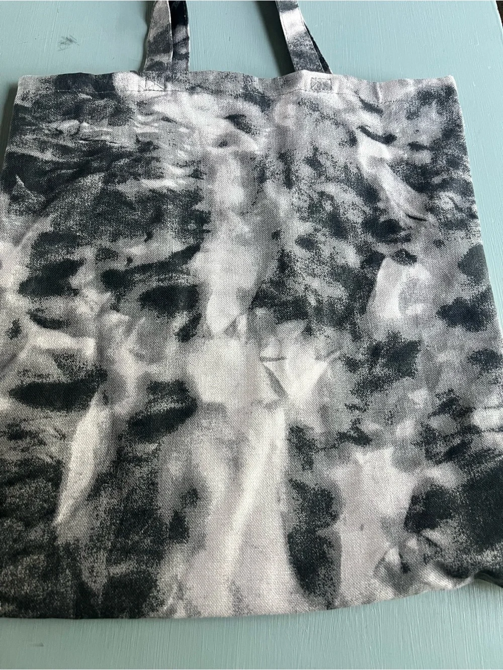 Medium tote bag black and white tie die “Strong than the Storm” on the bag
